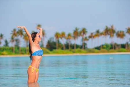 Young fashion woman in green dress on the beachの写真素材