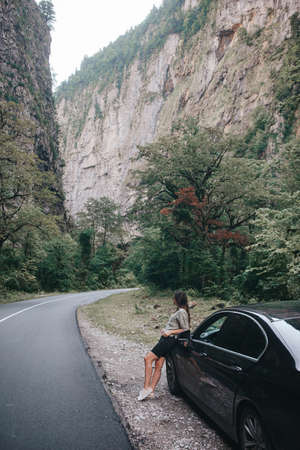 Travel concept. Young beautiful hipster woman travel by car