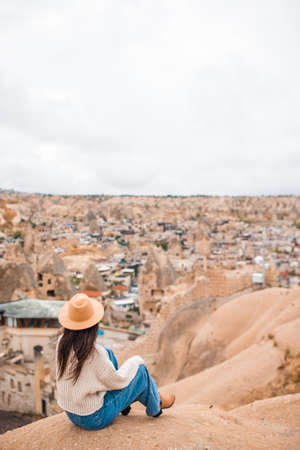 Young woman on the edge of canyon in Cappodociaの写真素材