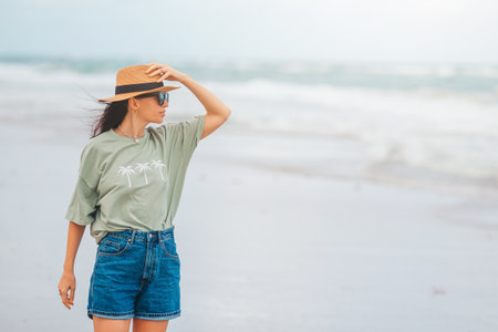 Young happy woman walking on the beachの写真素材