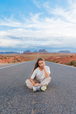Scenic highway in Monument Valley Tribal Park in Utah. Happy girl on famous road in Monument Valley in Utah.の写真素材