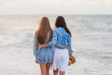 Beautiful mother and daughter at Carribean beach enjoying summer vacationの写真素材