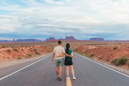 Happy couple on the famous road to Monument Valley in Utah. Amazing view of the Monument valley.の写真素材