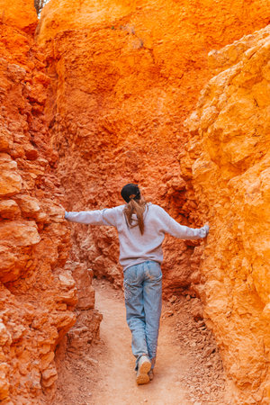 Hiker girl in Bryce Canyon hiking relaxing looking at amazing view during hike on summer travel in Bryce Canyon National Park, Utah, United States.の写真素材
