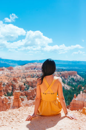 Hiker woman in Bryce Canyon resting enjoying view in beautiful nature landscape with hoodoos,...