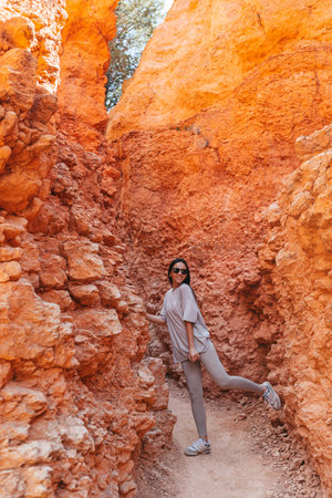 Hiker woman resting in beautiful nature landscape with hoodoos, pinnacles and spires rock formations in Bryce Canyon National Park landscape in Utah, United States.の写真素材
