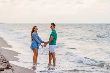 Adorable girl and happy dad having fun during beach vacationの写真素材