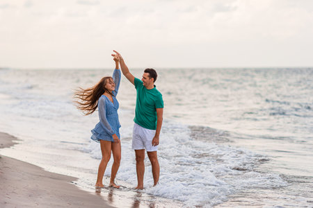 Adorable girl and happy dad having fun during beach vacationの写真素材