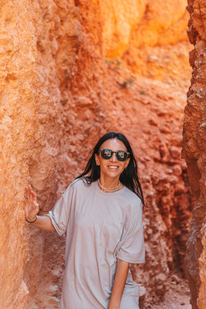 Hiker woman in beautiful nature landscape with hoodoos, pinnacles and spires rock formations. Bryce Canyon National Park in Utah, United States.の写真素材