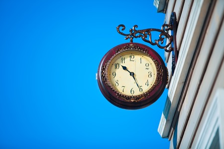 Street clock on the background of blue sky