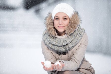 Happy young woman have fun and enjoy fresh snow at beautiful winter dayの写真素材