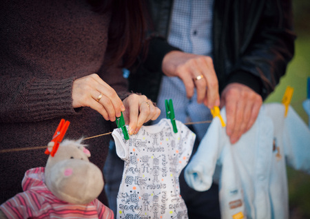 Pregnant Woman holding her hands in a heart shape on her baby bump. Pregnant Belly with fingers Heart symbol. Maternity concept. Baby Shower.の写真素材