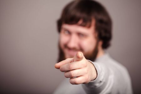 Happy businessman pointing his finger on you, close-upの写真素材