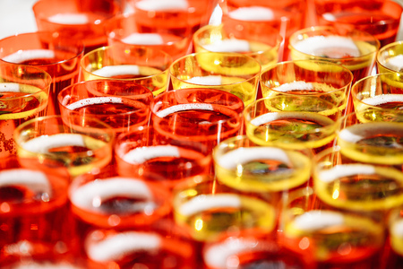 A lot of glasses with alcohol, coctail glasses close upの写真素材