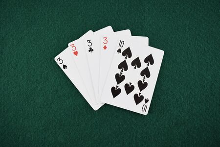 Four kind poker cards on a green tableの写真素材