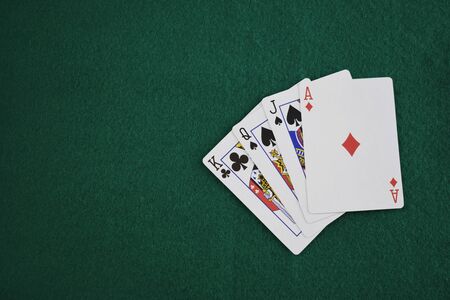 Poker cards on a green table, view topの写真素材