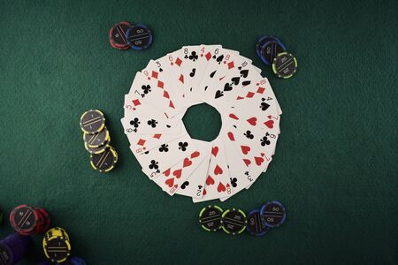 Circle made with poker cards on a green table