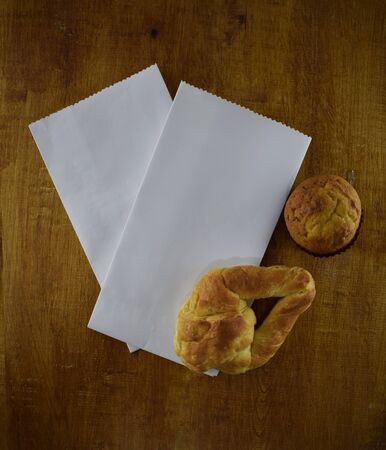 white paper bag with bread on woodの写真素材