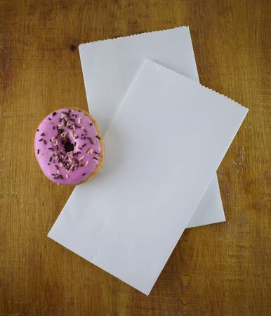 white paper bag with a pink donutの写真素材