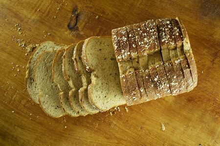 Bread on slices with wood backgroundの写真素材