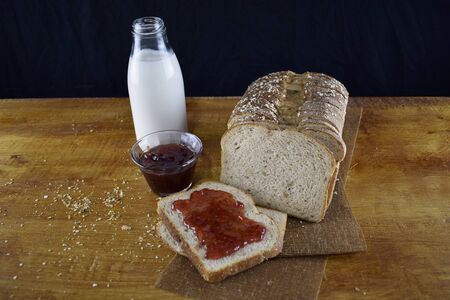milk, strawberry jelly and bread in slicesの写真素材