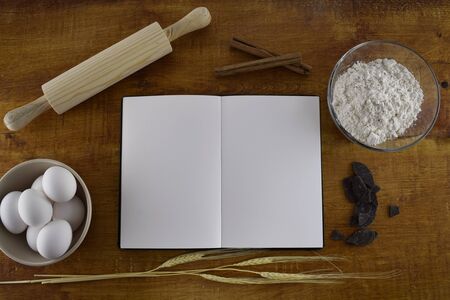 notebook with ingredients to bake on wood backgroundの写真素材