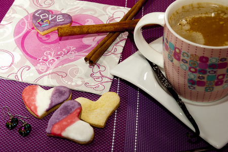 Delicious homemade cookies,coffee and an earrings as a symbol of loveの写真素材