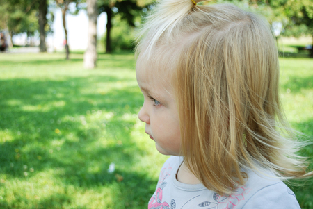 Little girl is playing in the parkの写真素材