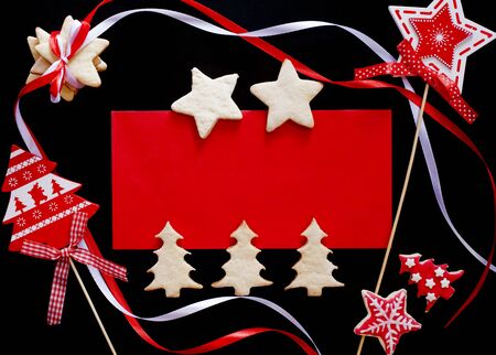 Winter frame: christmas decoration surrounding red envelope on black backgroundの写真素材