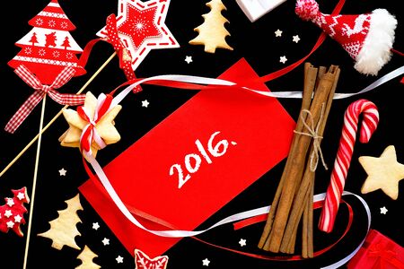 Winter frame: christmas decoration surrounding red envelope on black backgroundの写真素材