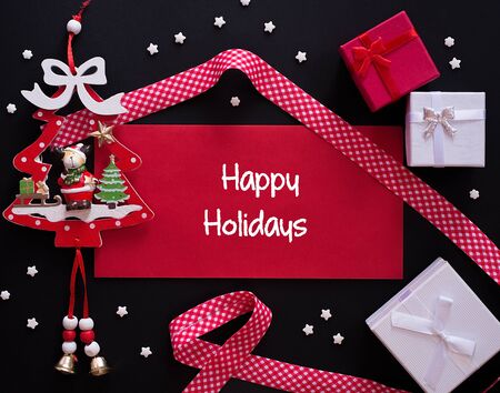 Winter frame: christmas decoration surrounding red envelope on black backgroundの写真素材