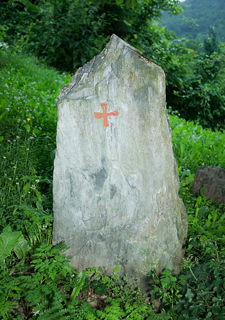 Gravestone without name in the middle of meadowの写真素材