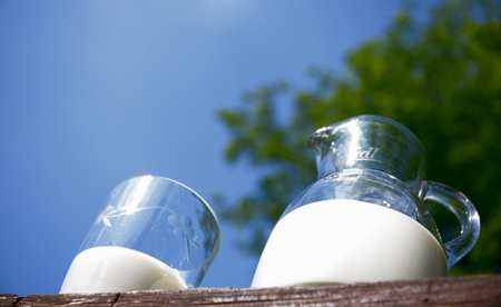 Jug of fresh milk facing the skyの写真素材