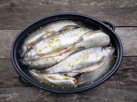 The raw trout prepared for baking