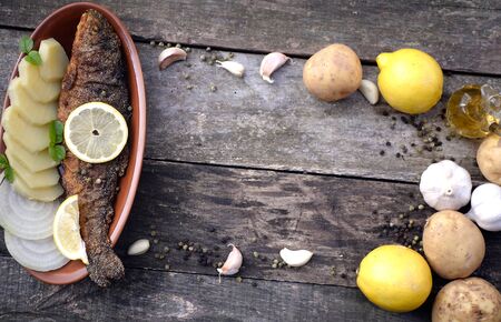 Baked trout fish with potatoesの写真素材