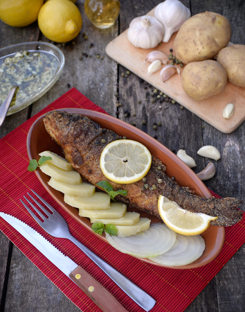 Baked trout fish with potatoesの写真素材