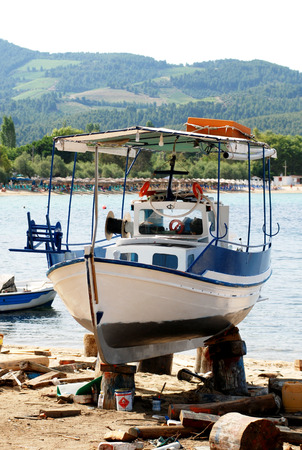 The boat is removed from the water ready for paintingの写真素材