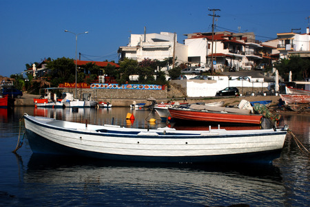 A small fishing boat is floating over a calm seaの写真素材