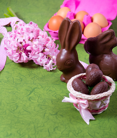 Easter decoration with flowers,sweets and eggs on green backgroundの写真素材
