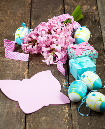 Easter decoration with a few colorful eggs on a wooden tableの写真素材