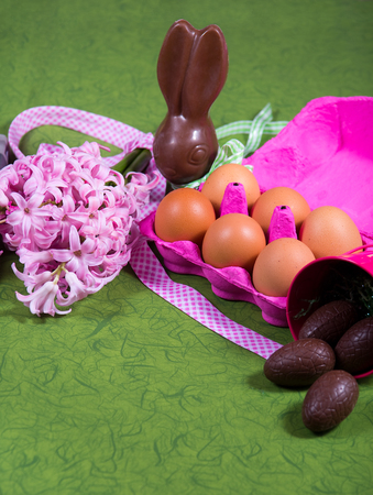 Easter decoration with flowers,sweets and eggs on green backgroundの写真素材