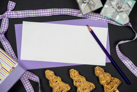 Winter frame: christmas decoration surrounding purple envelope on black backgroundの写真素材