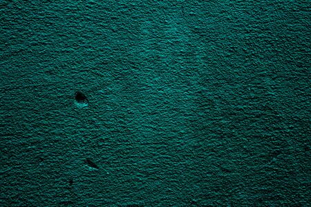Petrol colored wall texture background with textures of different shades of teal and the imprint of...