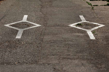 Diamond shape white markings on a roadの写真素材