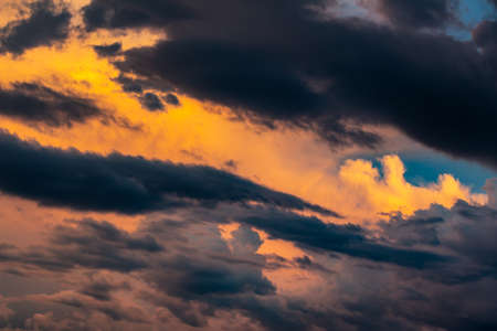 Blurry dramatic colorful cloudscape during sunset. Dark cloud pattern with copy space for text and...