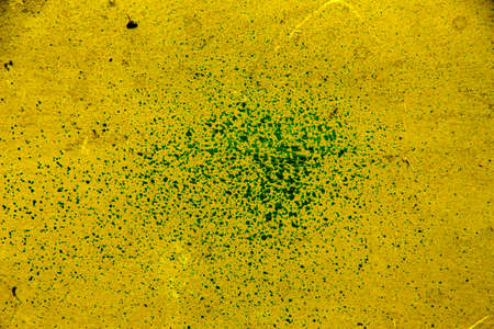 Yellow colored wall texture background with textures of different shades of yellow and dotted in the...