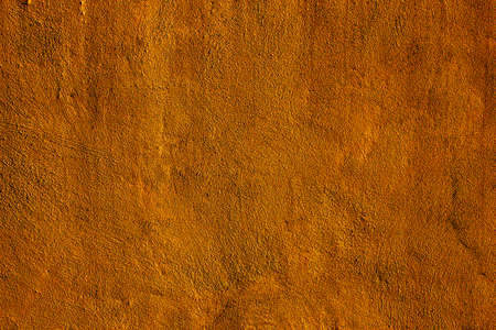 Copper colored wall texture background with textures of different shades of copper or bronze
