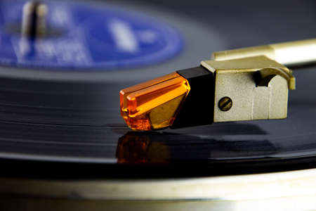 Close up of a turntable acoustic pickup with needle on a vinyl record, selective focusの写真素材