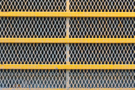 Close up full frame of a yellow radiator grille of a haul truckの写真素材
