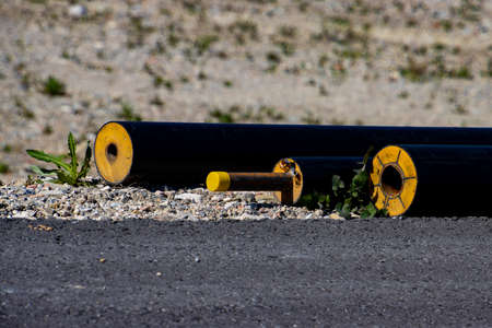 Black insulated district heating pipe laying on a construction siteの写真素材